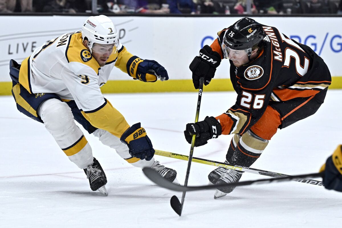 Ducks forward Brock McGinn, right, shoots in front of Nashville Predators defenseman Jeremy Lauzon.