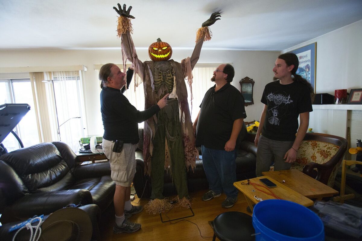 Jim Papageorge, left, and friends work on a prop for his family's Great Pumpkin attraction in 2015.