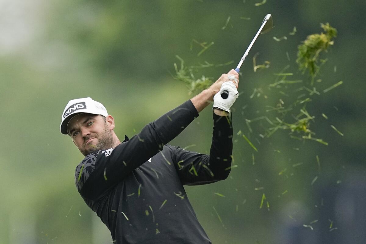 Corey Conners hits from the rough on the 16th hole during the third round of the PGA Championship on May 20, 2023.