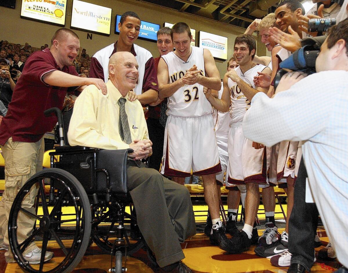 Northern State men's basketball coach Don Meyer, second from the left, celebrates his 903rd career victory, which propelled him to the top of the total career victories list in 2009. Meyer has died at 69.