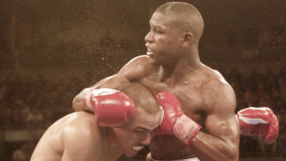Floyd Mayweather Jr., right, and Jose Luis Castillo battle during their rematch in 2002.