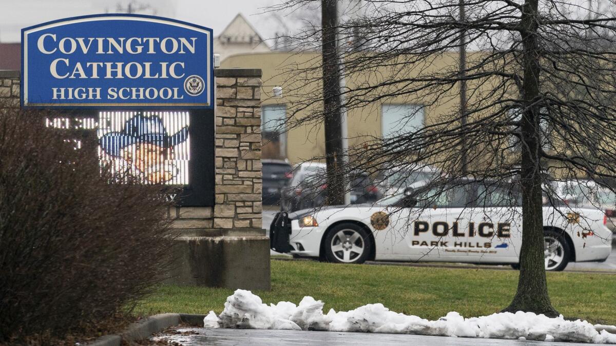 A police car sits at the entrance to Covington Catholic High School in Park Hills, Ky., on Saturday.