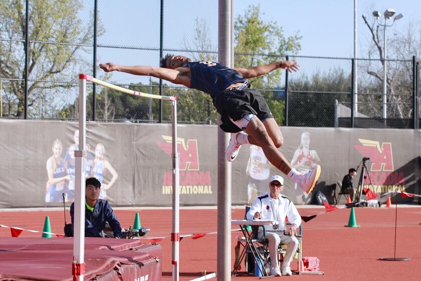 Birmingham senior Deshawn Banks clears the bar at six feet, nine inches to win the boys' high jump.