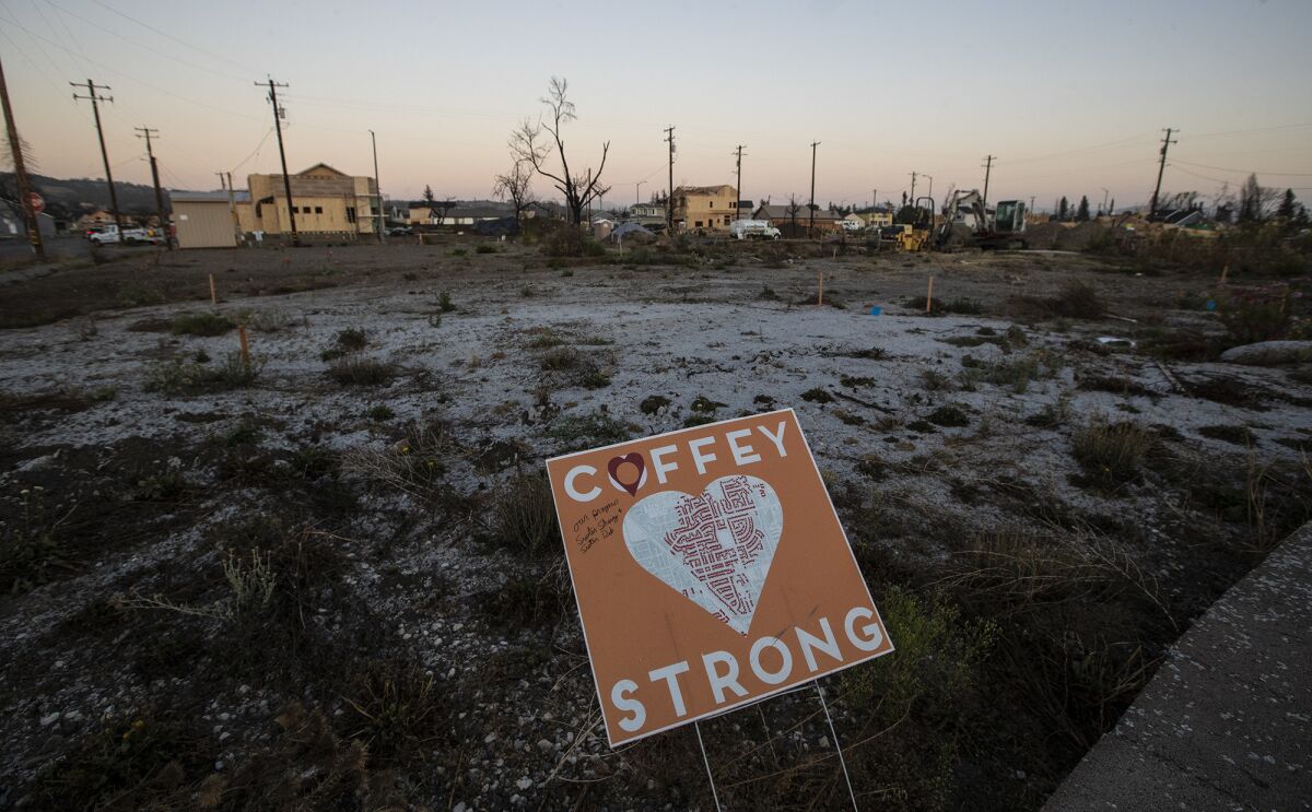 A sign where a home once stood in Coffey Park, encouraging rebuilding after the Tubbs fire in Santa Rosa, Calif.