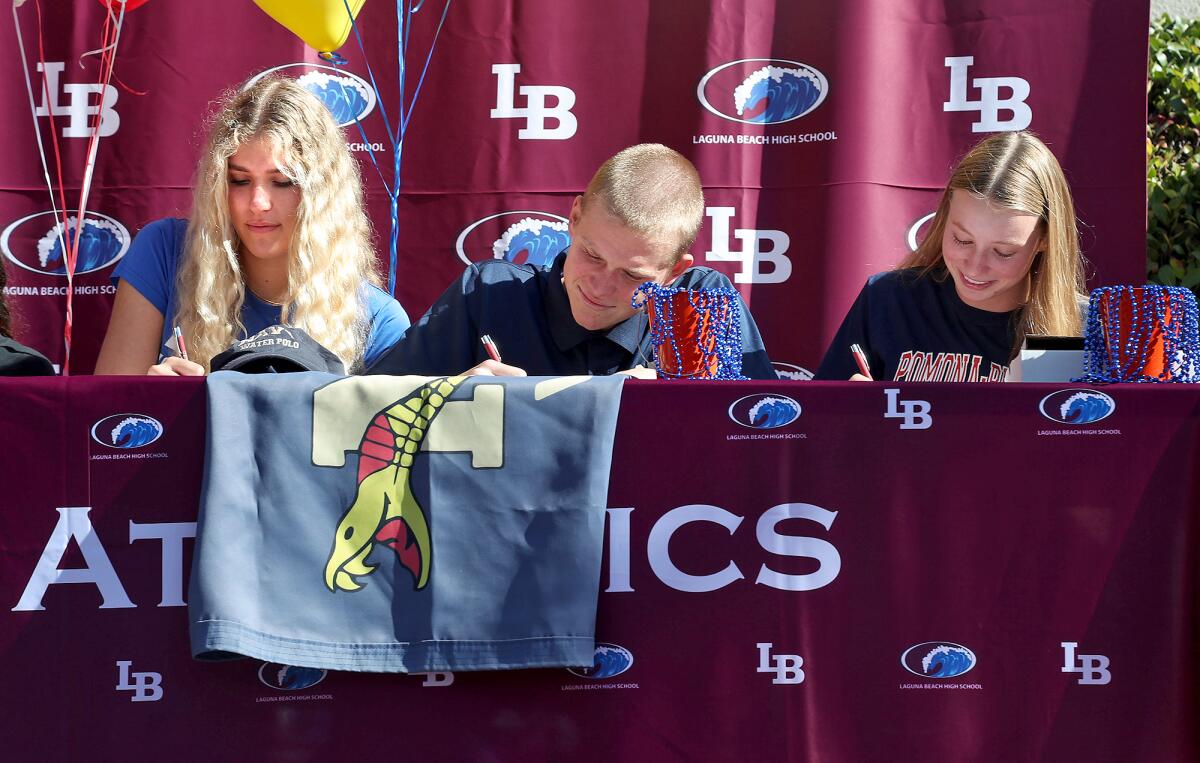 Sophie Reavis, Holden Seybold and Lauren Smith, from left, sign their letters of intent during a signing day ceremony.  