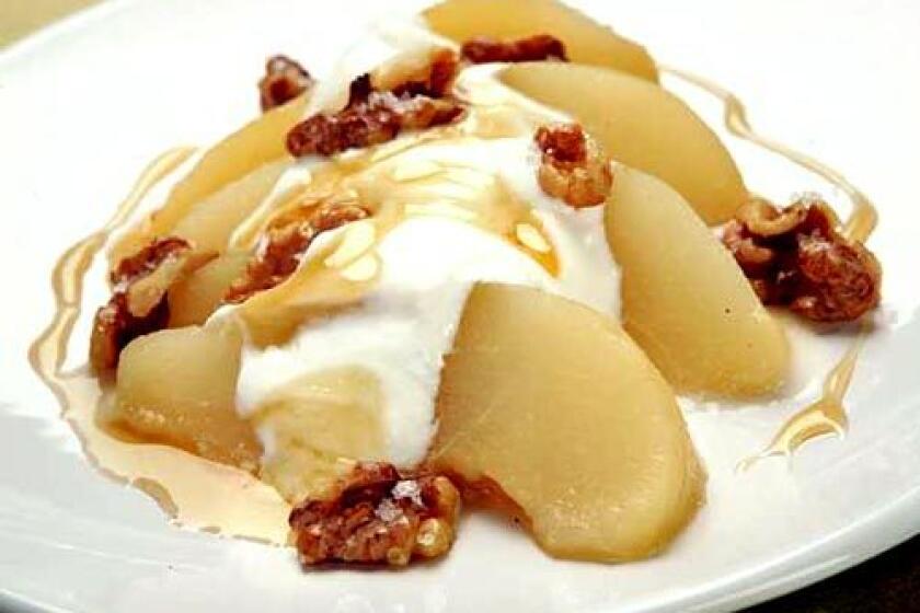 Toasted walnuts top an autumn dessert of honey-poached pear with Greek yogurt. Recipe: Honey-poached pears with Greek yogurt and toasted walnuts