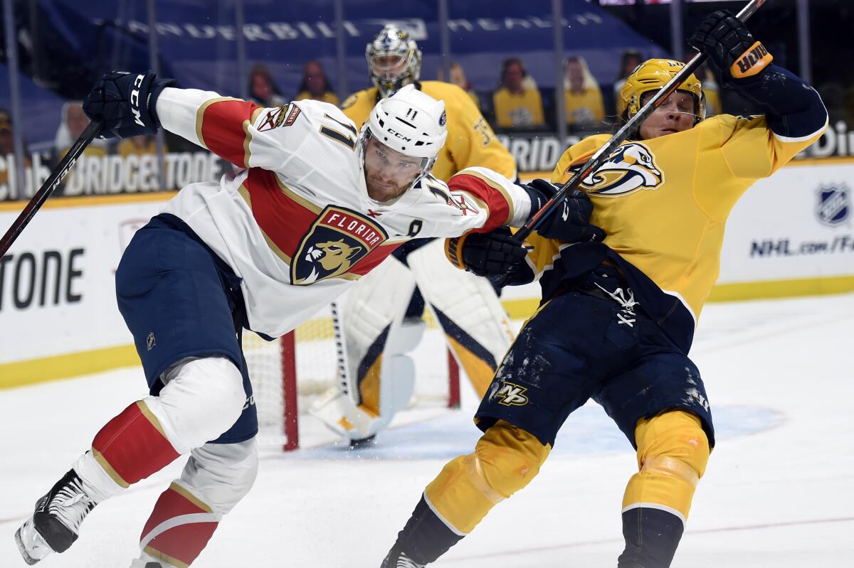 Florida Panthers left wing Jonathan Huberdeau (11) pushes Nashville Predators center Mikael Granlund (64) as they chased the puck during the third period of an NHL hockey game Thursday, March 4, 2021, in Nashville, Tenn. (AP Photo/Mark Zaleski)