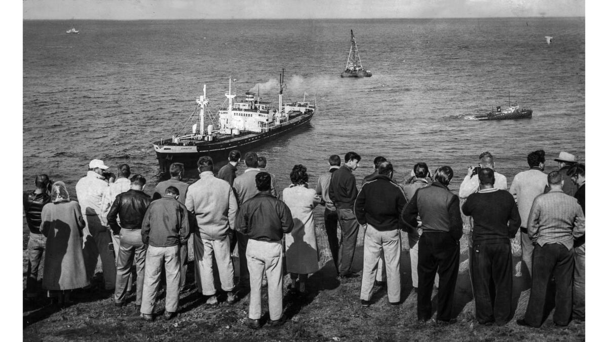 March 15, 1961: Crowd gathered at Rocky Point in Palos Verdes Estates to watch as a tug attempts to refloat the merchant ship Dominator. The ship would not budge.