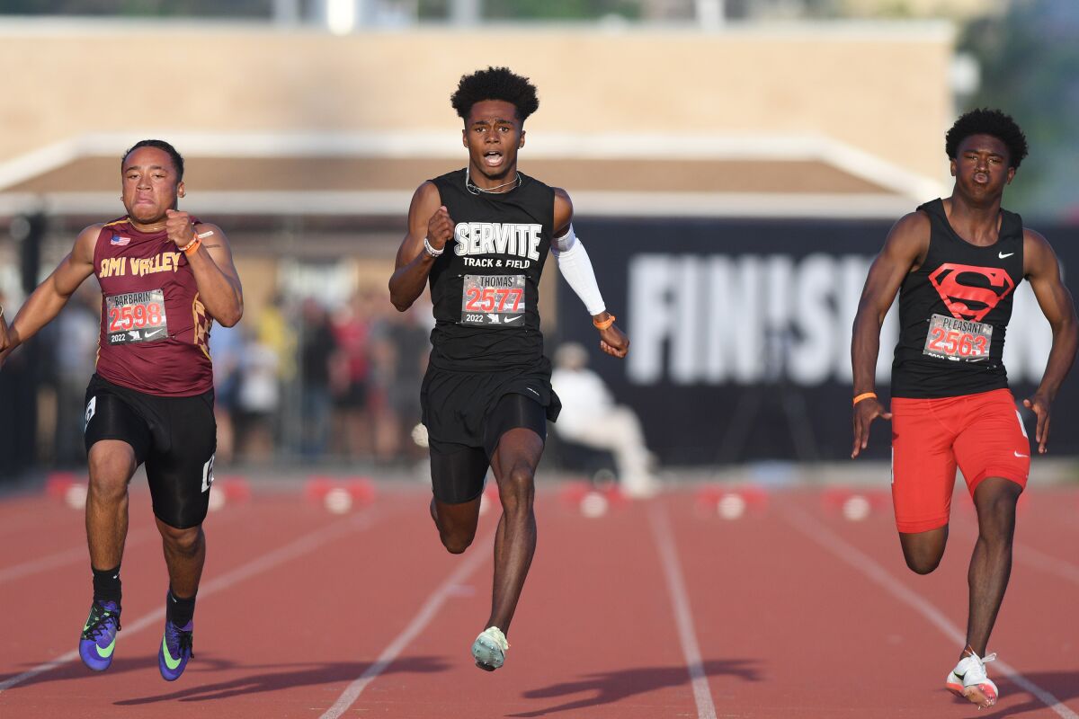 Servite's Max Thomas, center, wins the boys' 100 meters at the Arcadia Invitational on Saturday.