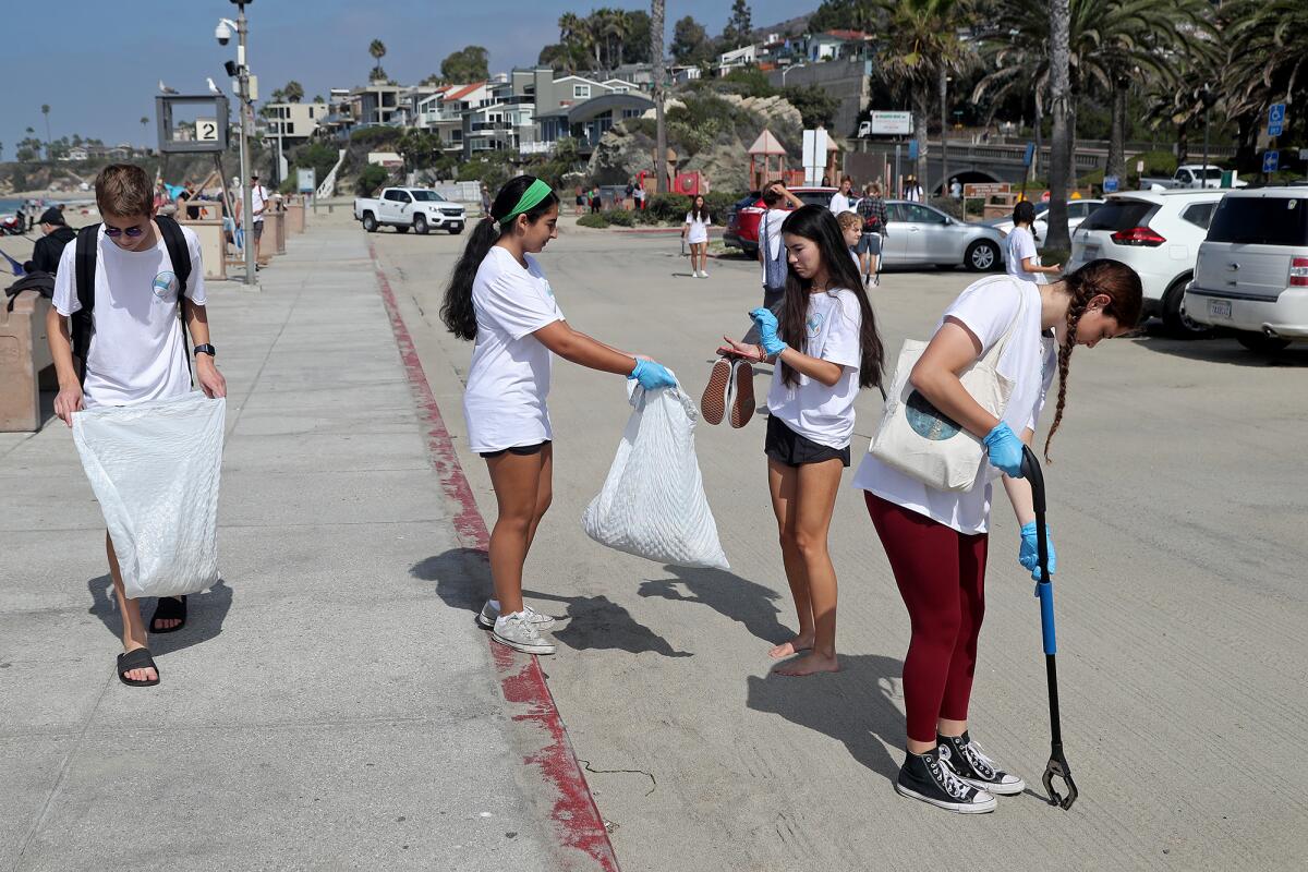 Laguna Beach High School students help collect trash at Aliso Beach. 