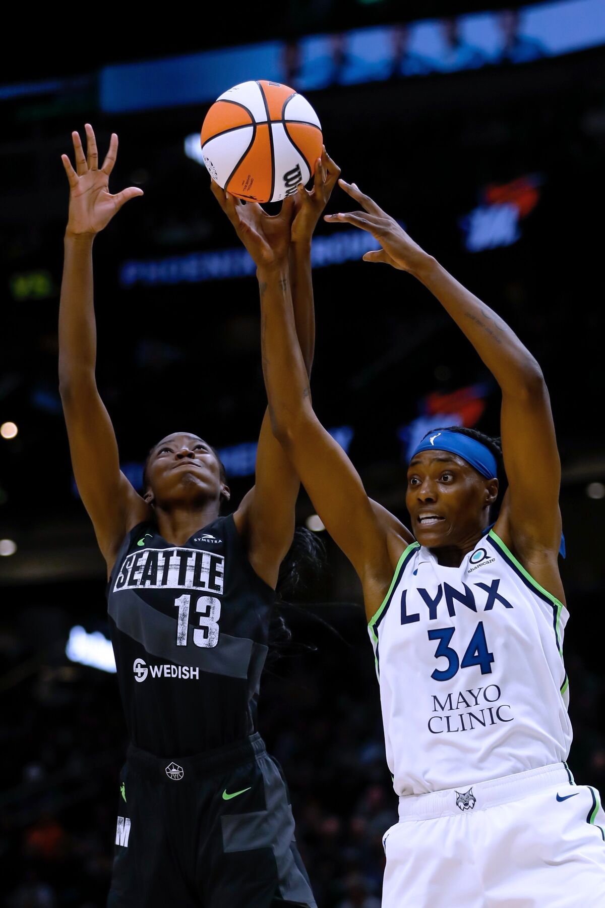 Seattle Storm center Ezi Magbegor vies for a rebound with Minnesota Lynx center Sylvia Fowles during the second quarter of a WNBA basketball game Friday, May 6, 2022, in Seattle. (Jennifer Buchanan/The Seattle Times via AP)