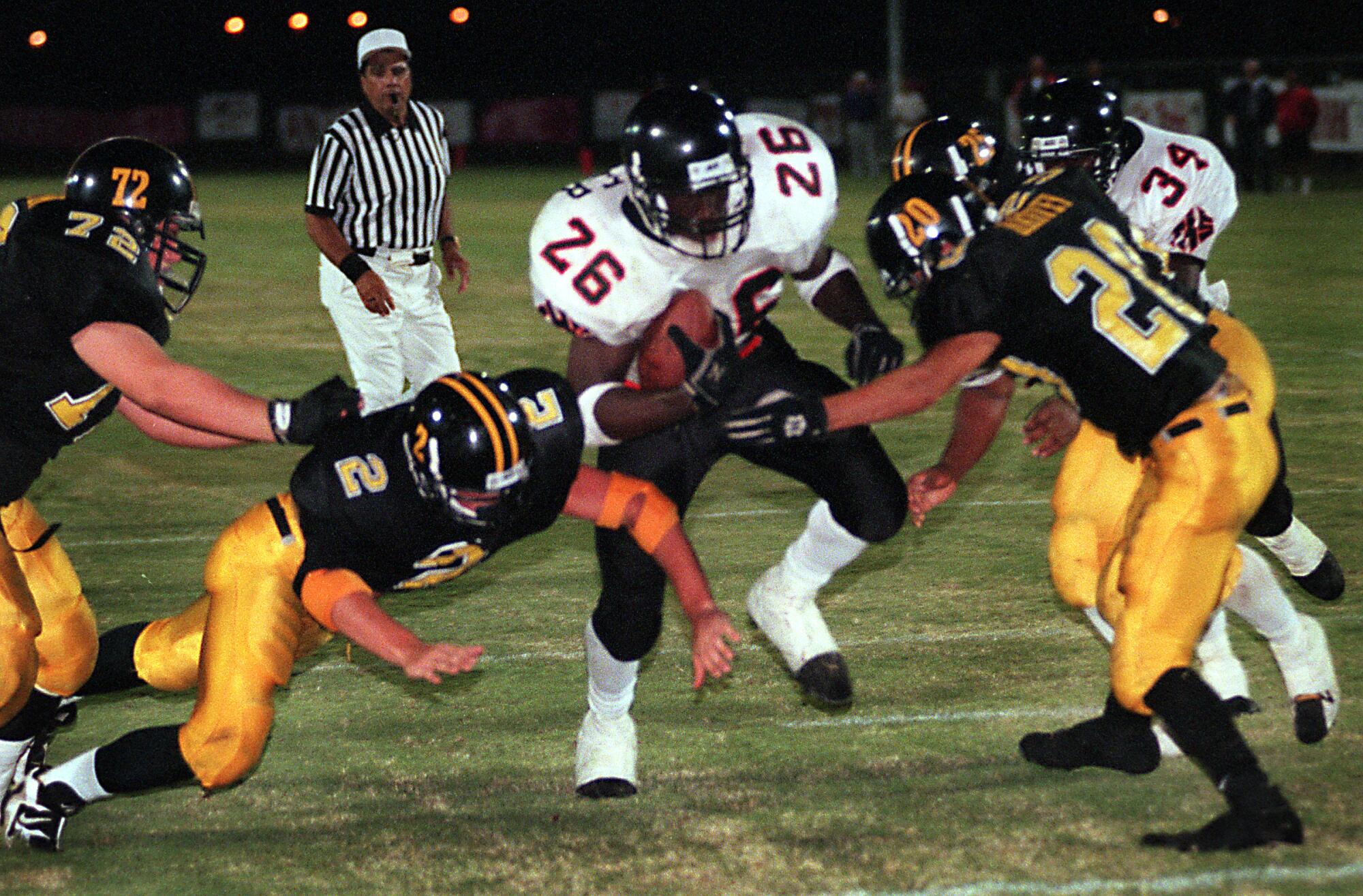 Tustin High tailback DeShaun Foster drives his way toward a touchdown.