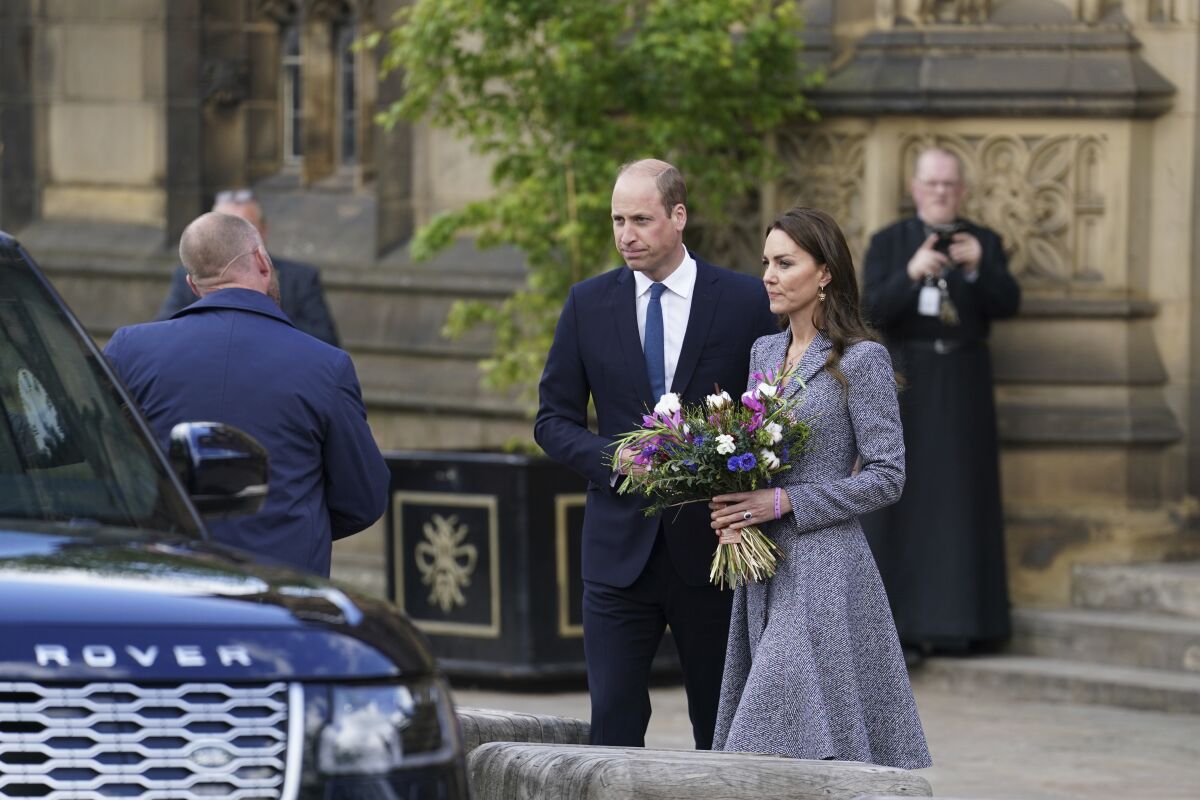 Britain's Prince William and his wife Kate the Duchess of Cambridge leave after attending the launch of the Glade of Light Memorial, outside Manchester Cathedral, which commemorates the victims of a suicide bomb attack at a 2017 Ariana Grande concert, in Manchester, England, Tuesday, May 10, 2022. The memorial honours the 22 people whose lives were taken, as well as remembering everyone who was left injured or affected by the attack at Manchester Arena on May 22, 2017. (AP Photo/Jon Super)