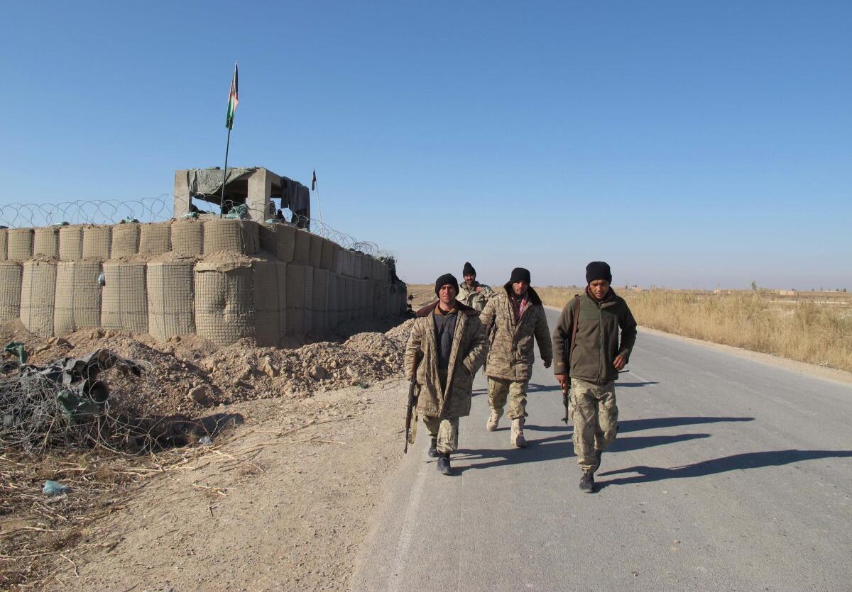Afghan security forces patrol near their base in the Marjah district of Helmand Province on December 23, 2015. On Tuesday, Jan. 5, 2016, one American service member was killed and two wounded in the district.