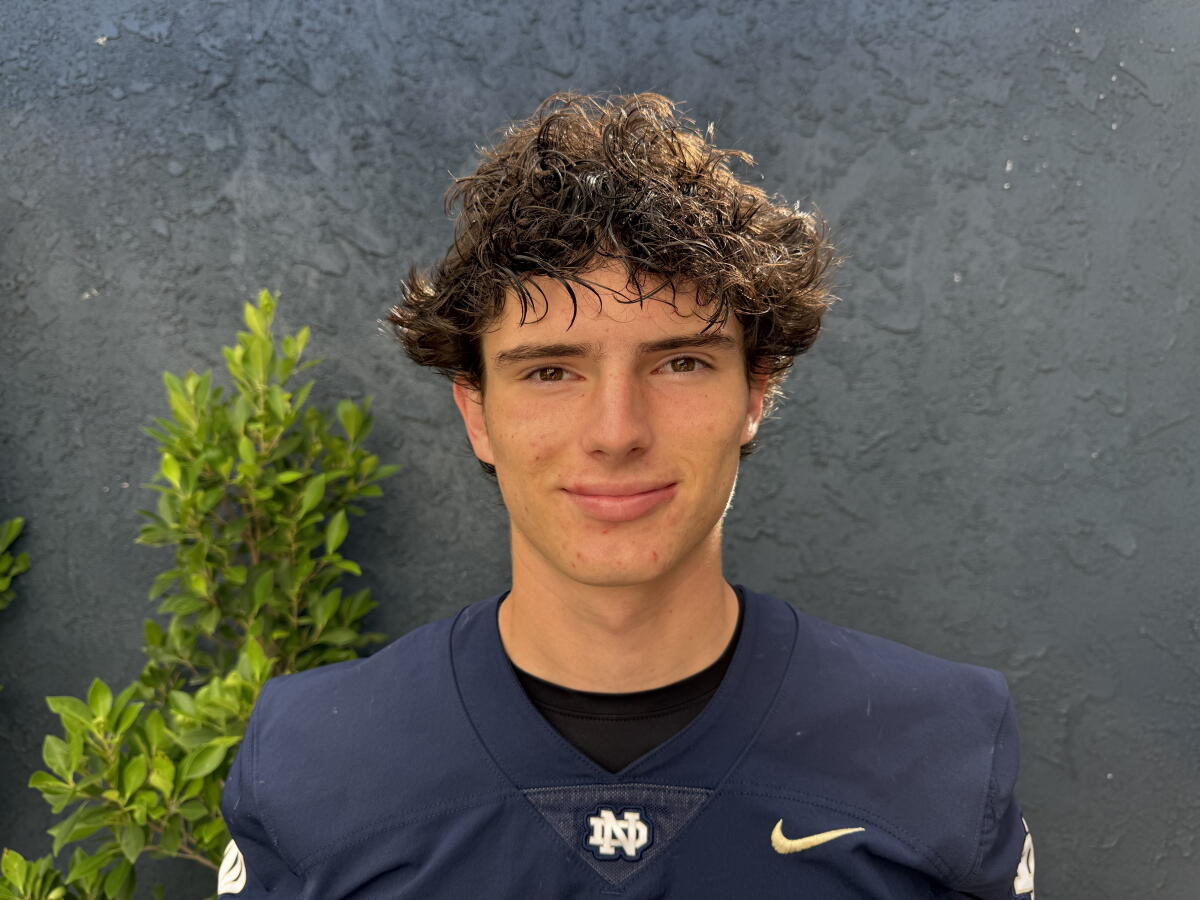 Sherman Oaks Notre Dame kicker Charles Szares oses for a photo while wearing his jersey.