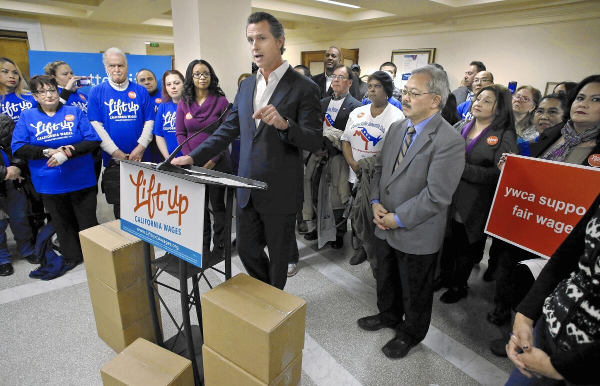 California Lt. Gov. Gavin Newsom and San Francisco Mayor Ed Lee address supporters of a ballot initiative asking voters to raise California's minimum wage to $15 per hour, on Jan. 19.