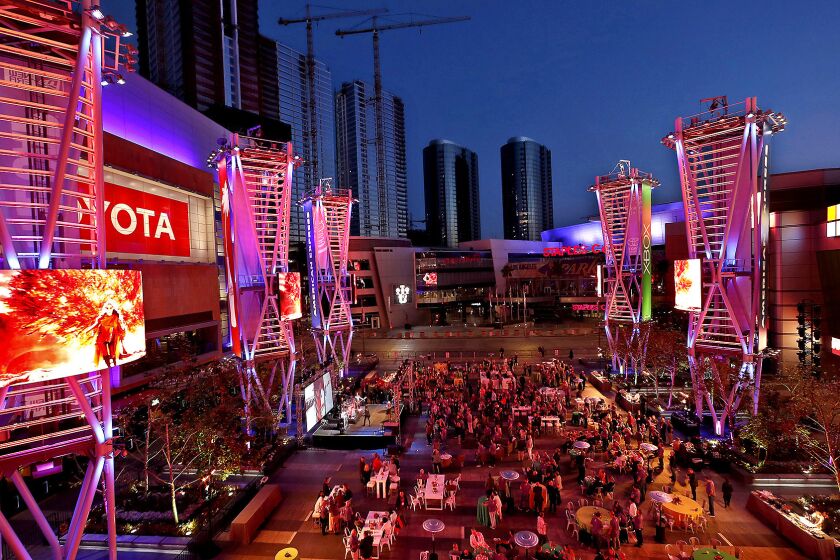 People gather inside the courtyard at L.A. LIve in downtown Los Angeles during a private event on June 6, 2018. L.A. LIve and Staples Center together have served as a catalyst for billions of dollars worth of development in the South Park area of downtown.