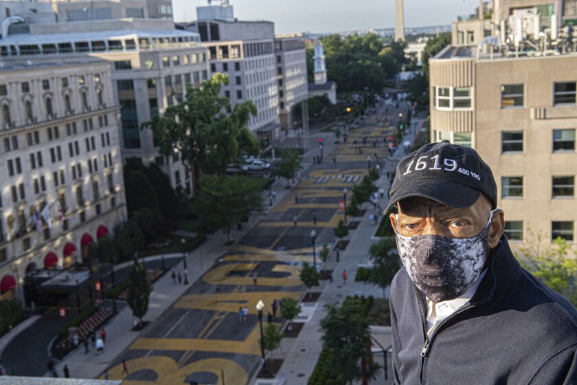 In a June 7, 2020, photo, John Lewis looks over a section of 16th Street renamed Black Lives Matter Plaza in Washington, D.C.