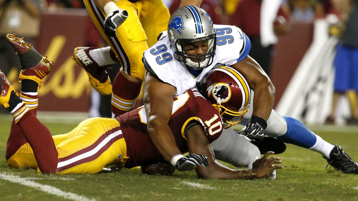 Washington quarterback Robert Griffin III is hit by Detroit defensive end Corey Wootton while trying to recover a fumble in the first half of a preseason game on Thursday night. Griffin was injured on the play.
