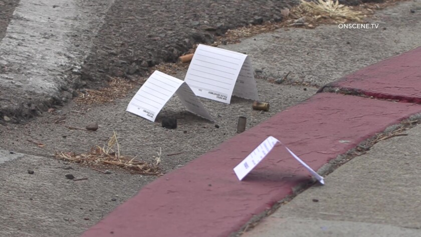 Evidence markers near bullet casings at Ulric Street homicide