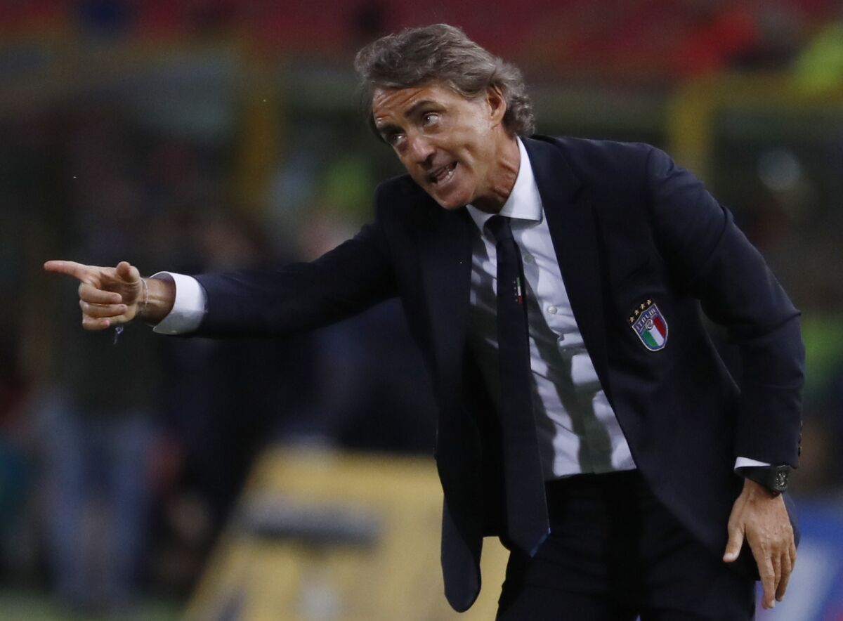 FILE - In this Friday, Sept. 7, 2018 file photo, Italy coach Roberto Mancini gestures during the UEFA Nations League soccer match between Italy and Poland at Dall'Ara stadium in Bologna, Italy. Italy coach Roberto Mancini has tested positive for the coronavirus days before the international break. The Italian soccer federation says that Mancini is “completely asymptomatic” and is self-isolating at his house in Rome. The Italy squad will meet up on Sunday. It plays an international friendly against Estonia on Wednesday and hosts Poland in the Nations League four days later. (AP Photo/Antonio Calanni, File)
