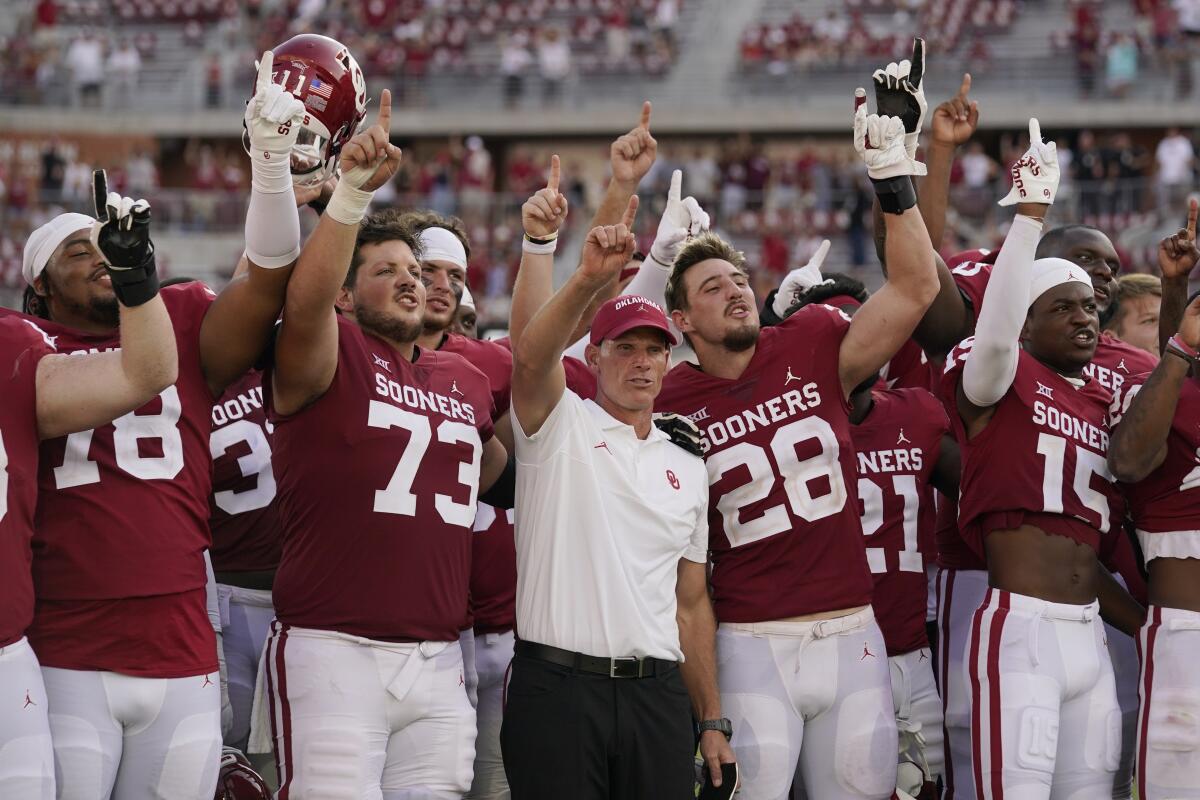 Oklahoma coach Brent Venables, middle, celebrates with his players after a win over UTEP.