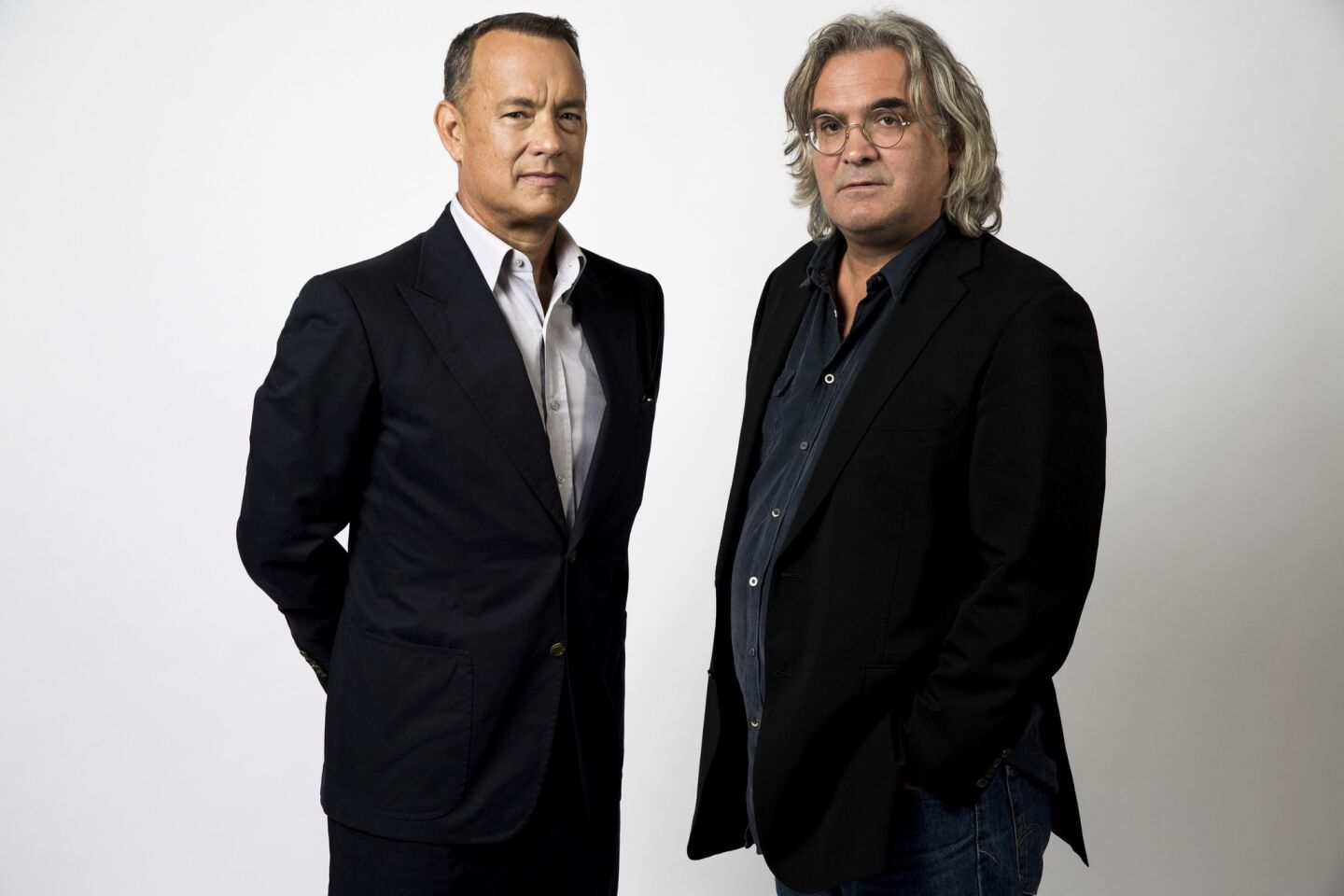 "Captain Phillip's" star Tom Hanks, left, and director Paul Greengrass wanted to keep the film tense. Unusual casting and shooting at sea helped.