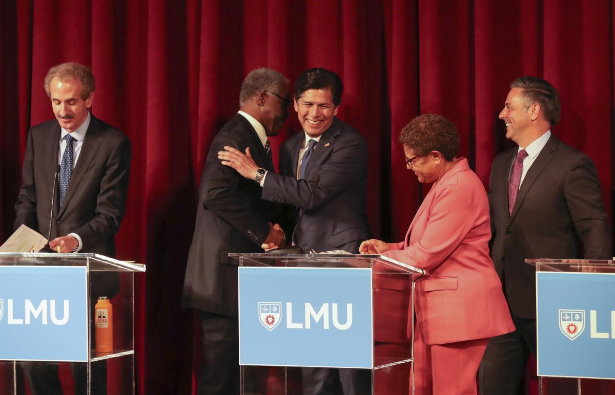 Los Angeles mayoral candidates shake hands after the debate at Loyola Marymount University.