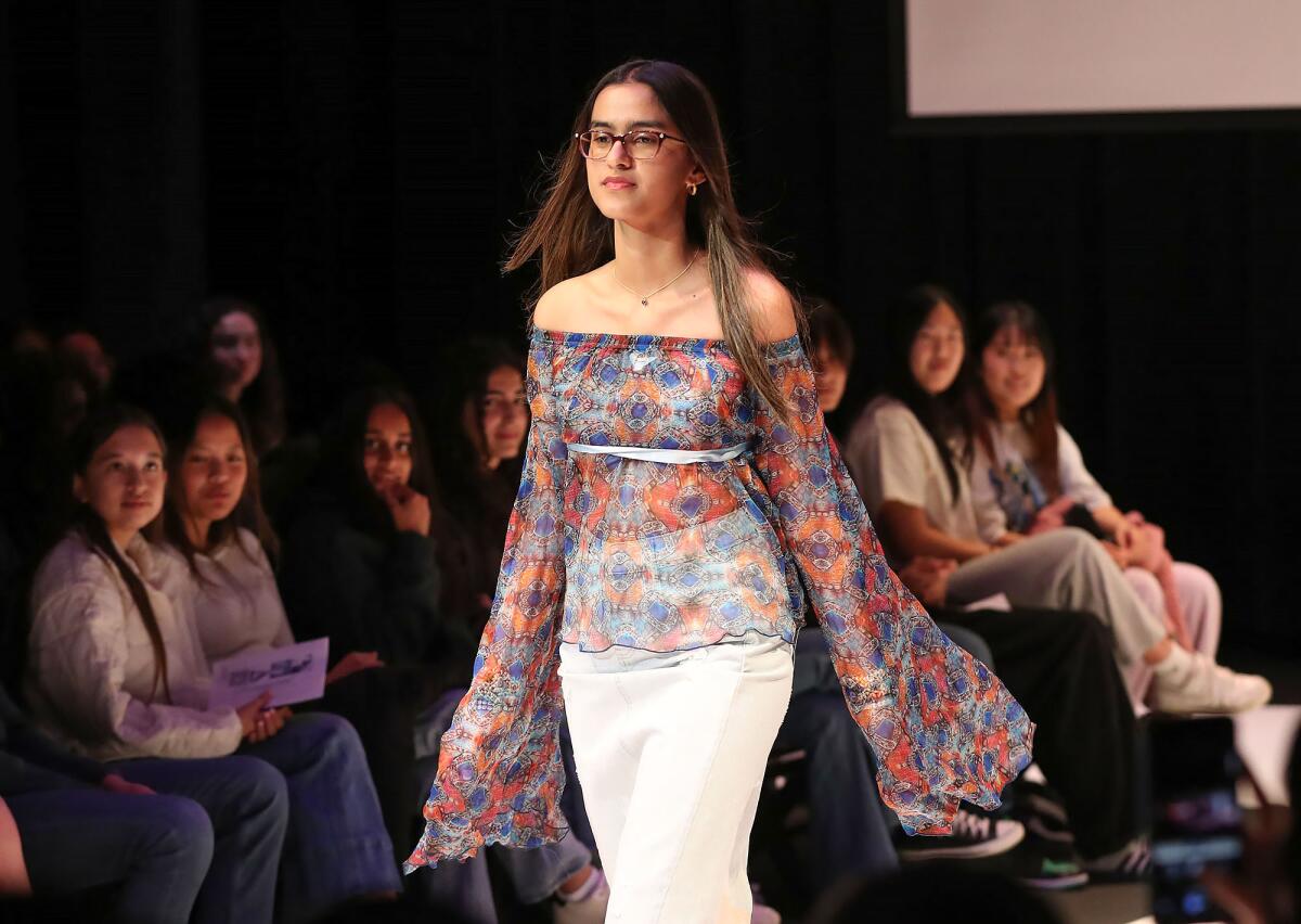 Model Karmen Sandhu walks the runway during the Reimagined Fashion Upcycling Club show.