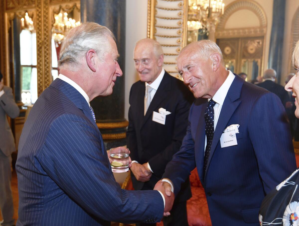 Then-Prince Charles of Britain shaking hands with Len Goodman, judge on “Dancing With the Stars” and “Strictly Come Dancing"