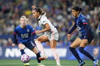 Angel City FC forward Sydney Leroux, center, makes a short pass in front of the goal.