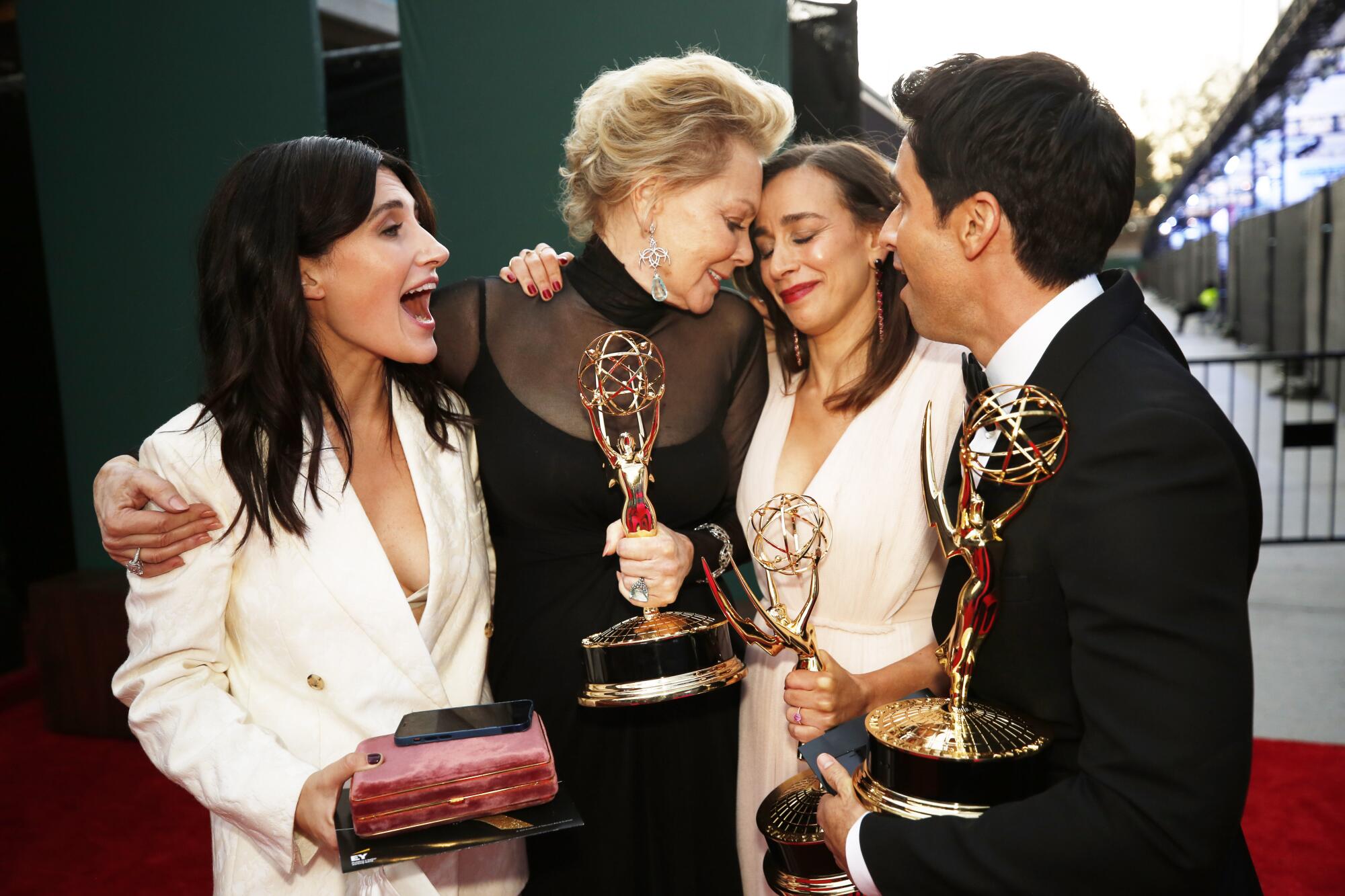 Jen Statsky, Jean Smart, Lucia Aniello and Paul W. Downs with their Emmy awards.
