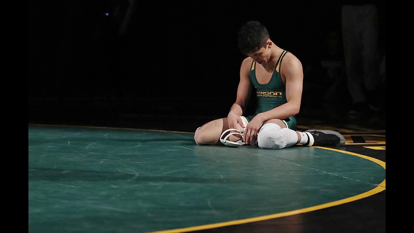Edison's Elijah Palacio hangs his head on following a loss to Fountian Valley's Max Wilner during a Sunset League meet on Wednesday, January 24.