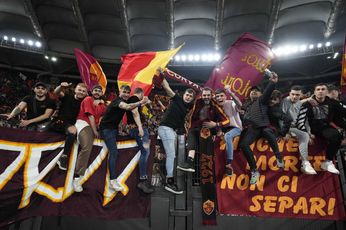 Roma supporters celebrate at the end of a Conference League semifinal second leg soccer match between Roma and Leicester City, at Rome's Olympic Stadium, Thursday, May 5, 2022. Roma won 1-0. (AP Photo/Andrew Medichini)