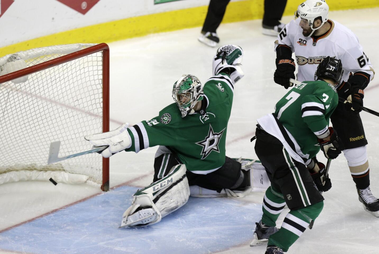 Dallas Stars goalie Kari Lehtonen gives up the winning goal on a shot by Ducks forward Nick Bonino (not shown) as Ducks forward Patrick Maroon looks on in the team's 5-4 series-clinching victory in Game 6 of the Western Conference quarterfinals.