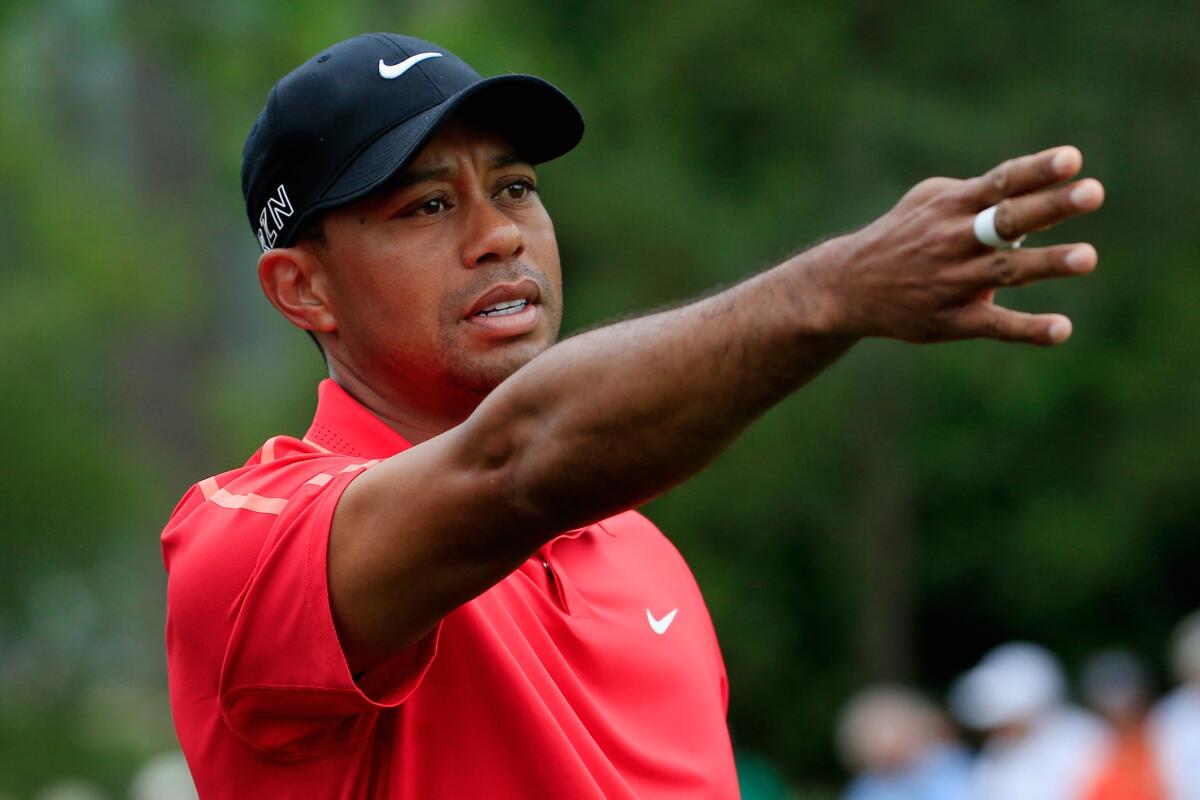 Tiger Woods waits to play a shot on the first hole of the final round of the Masters at Augusta National.