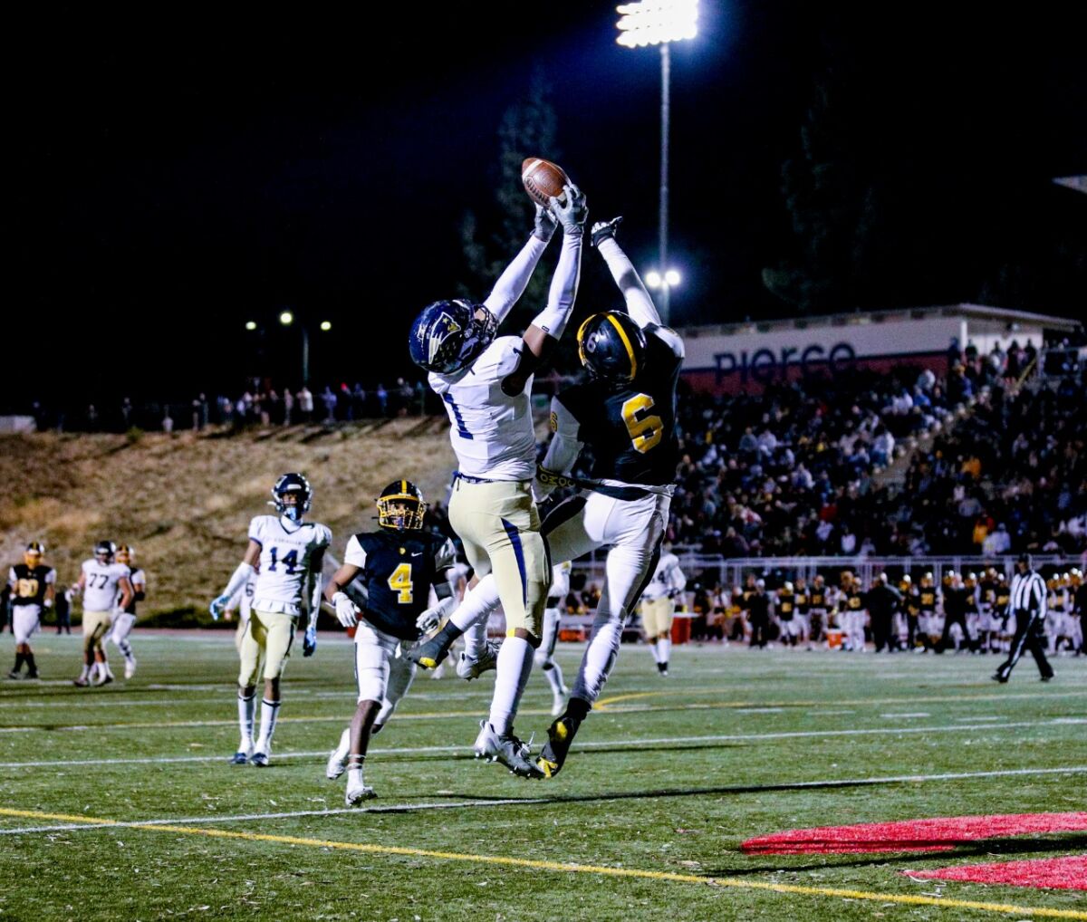 Arlis Boardingham stills the ball away from the San Pedro defender in the end zone for a Birmingham touchdown.