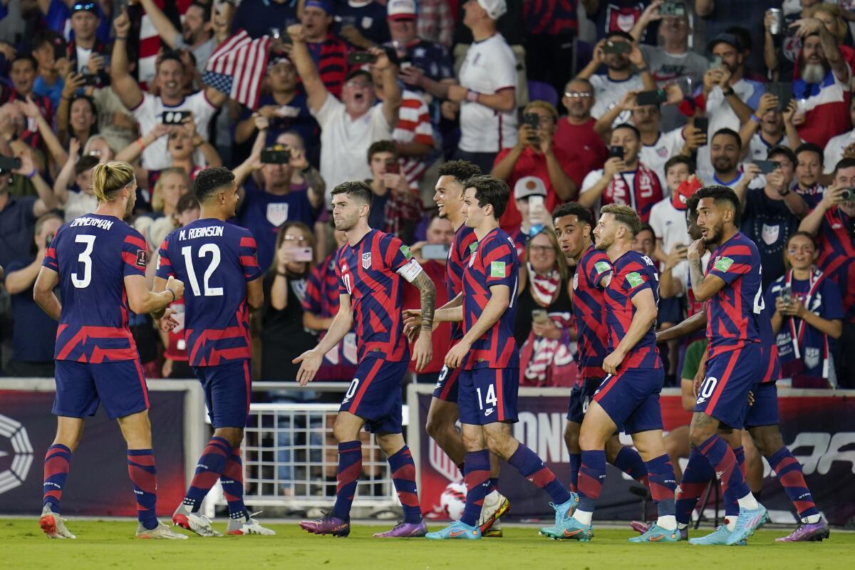 American Christian Pulisic, third from left, celebrates with teammates after scoring on a penalty kick against Panama 