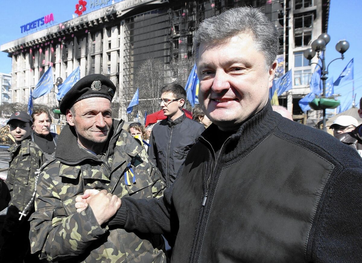 Ukrainian billionaire Petro Poroshenko, right, is the front-runner in the field of 21 presidential candidates.