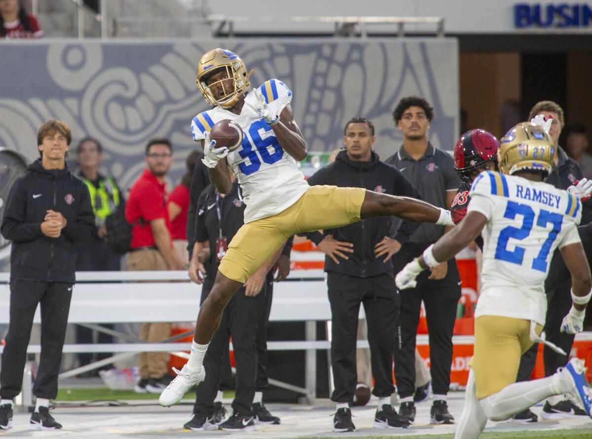 UCLA defensive back Alex Johnson makes an interception in the second half against San Diego State.