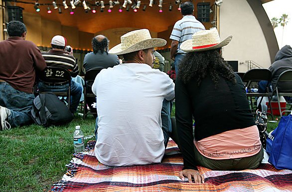 A couple relaxes on the grass during the Central American Independence Day celebration at MacArthur Park in Los Angeles.