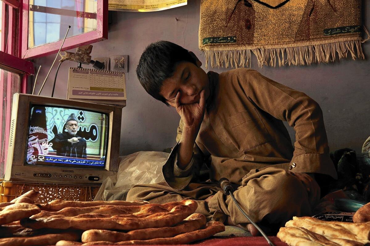 Sami Rahimi, 13, works and lives in a bread bakery in Kabul. He gets up at 5 a.m. to start work. He supports his entire family, who live in the northern province of Tahar.