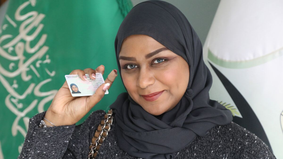 Sarah Saleh holds up her driver's license in "Saudi Women's Driving School " on HBO.