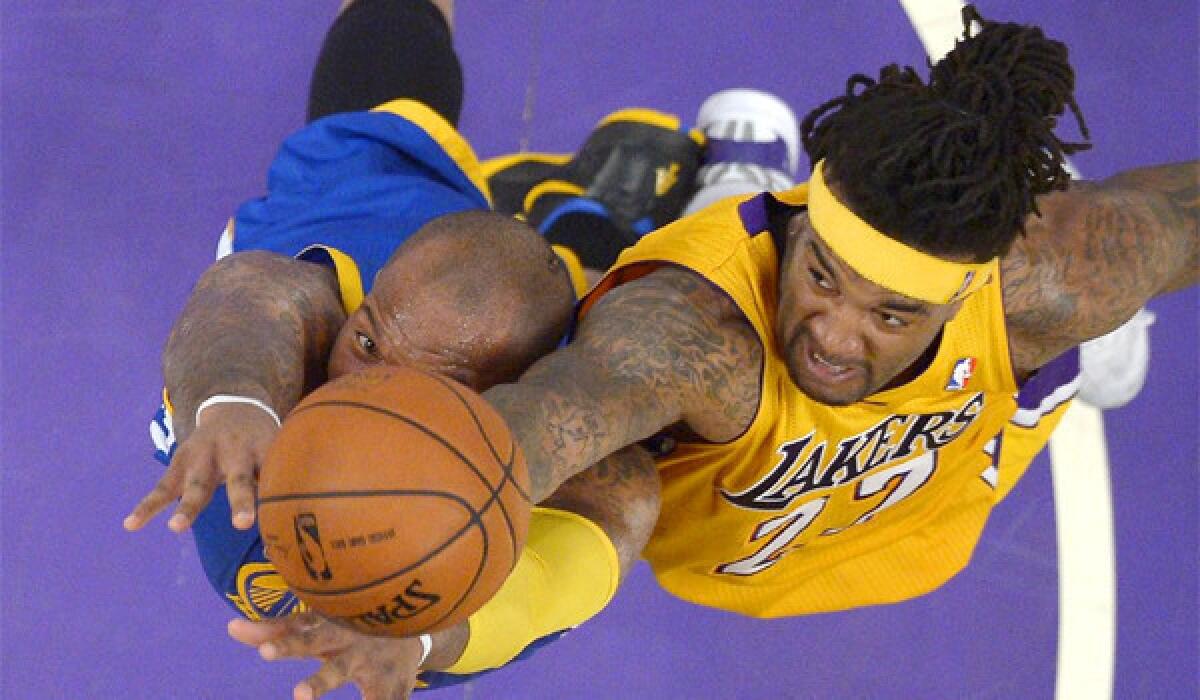 Jordan Hill, right, and Golden State's Marreese Speights, left, reach for a rebound during the first half of a game Friday.