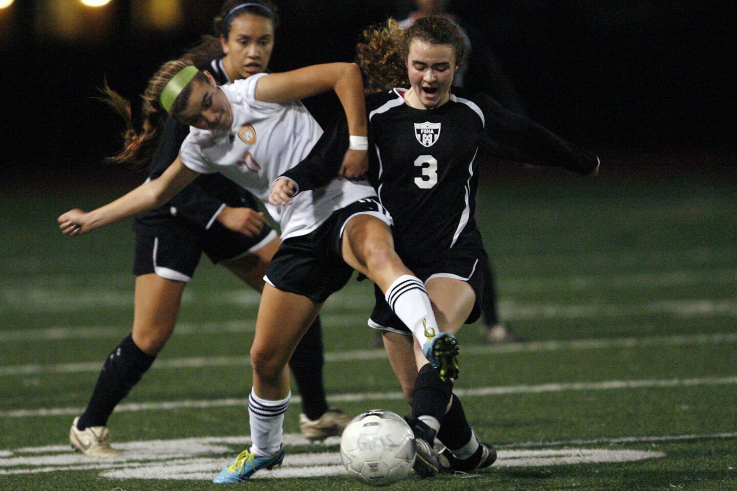 South Pasadena's Ryan Ramirez, left, and FSHA's Lauren Savo fight for the ball during a game at South Pasadena High School on Thursday, December 13, 2012.