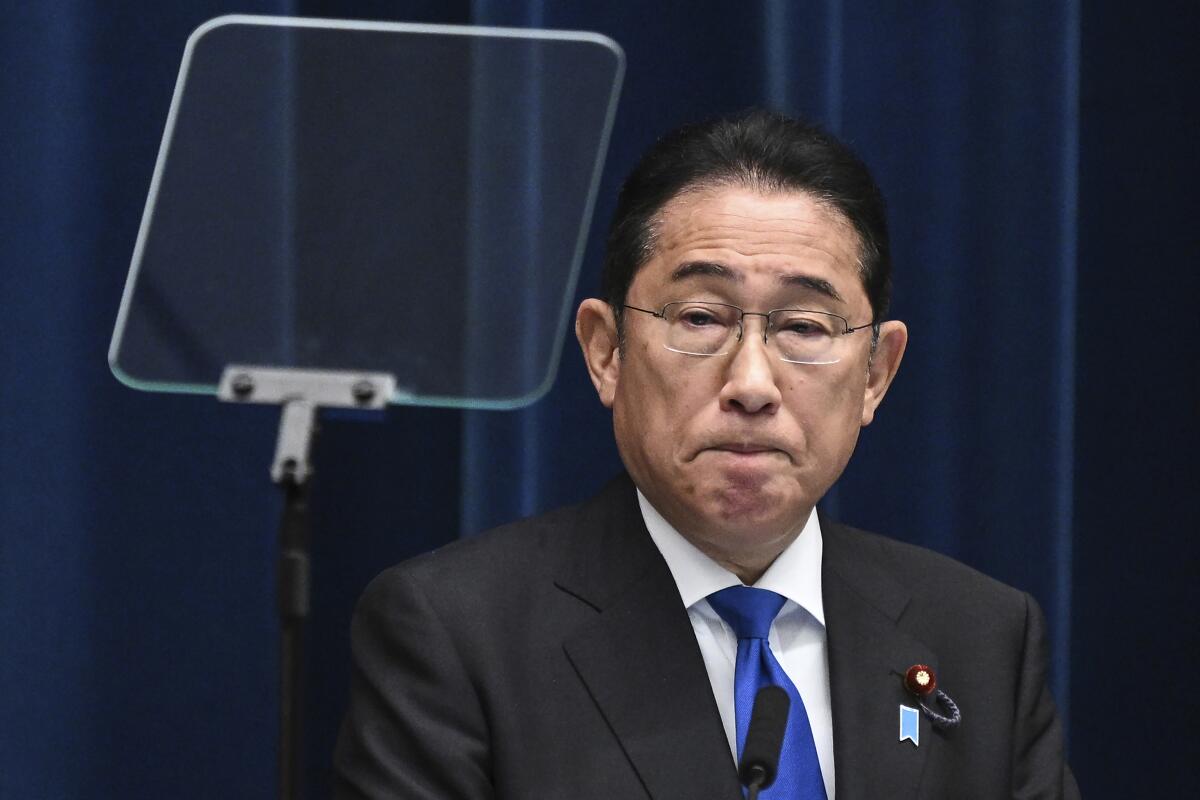 Japan's Prime Minister Fumio Kishida is shown near a teleprompter screen. 