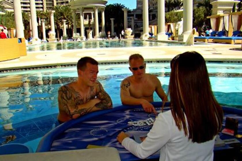 Benjamin Jensen, left, and Peter Andersen of Denmark get a blackjack lesson in the Caesars Palace pool.