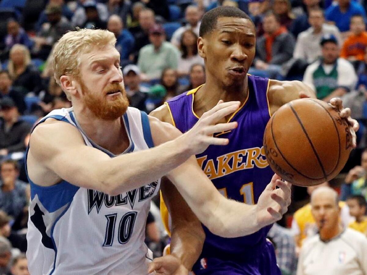 Lakers forward Wesley Johnson knocks the ball free from Timberwolves forward Chase Budinger during the first quarter.