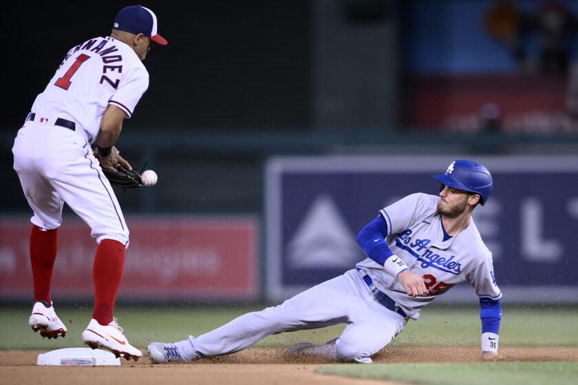 Los Angeles Dodgers' Cody Bellinger, right, steals second against Washington Nationals second baseman.
