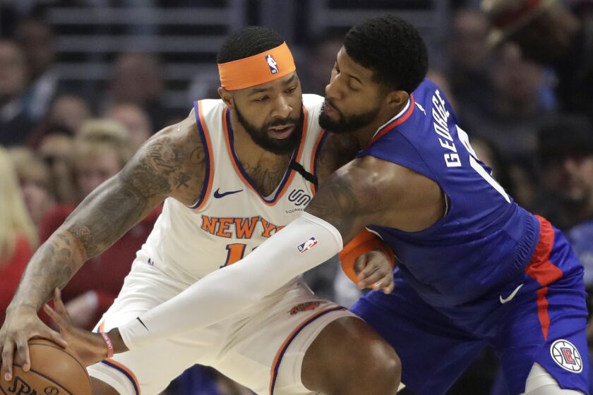 New York Knicks' Marcus Morris Sr., left, is defended by Los Angeles Clippers' Paul George during the first half of an NBA basketball game Sunday, Jan. 5, 2020, in Los Angeles. (AP Photo/Marcio Jose Sanchez)